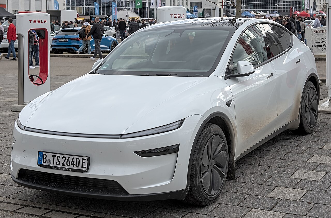 一辆漆面洁净的白色特斯拉Model Y，展示日常洗车养护后的车漆光泽