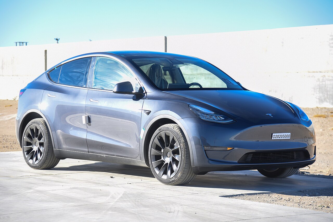 Front three-quarter view of a Tesla Model Y showing the areas where the exterior cameras are mounted