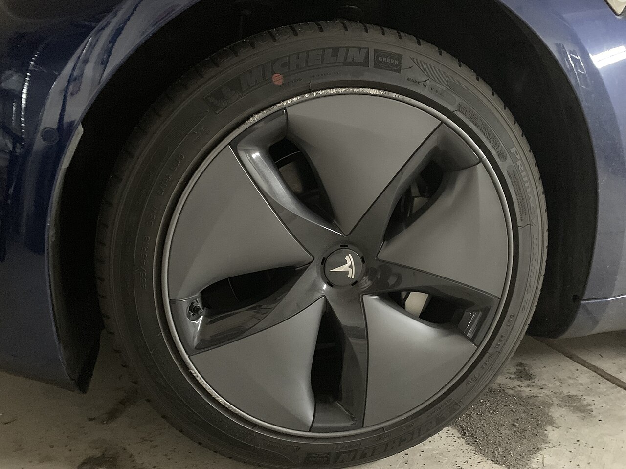 Close-up of a Tesla Model 3 aero wheel and tire, which has no spare tire from the factory