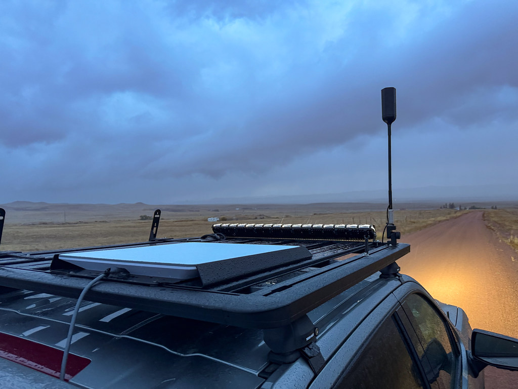 Starlink flat-panel satellite dish mounted on the roof of a truck for mobile internet